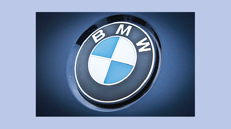 BMW profits slump as legal woes, investment costs bite