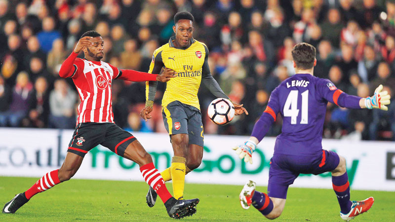 Walcott treble helps Arsenal dump Saints out of FA Cup