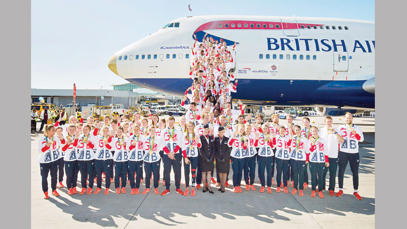 Triumphant Brits return home in gold-nosed plane 