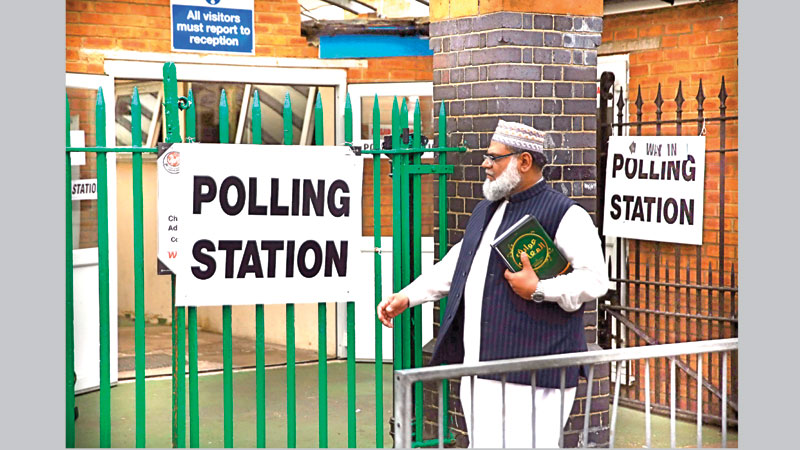 Britons vote in shadow of terror