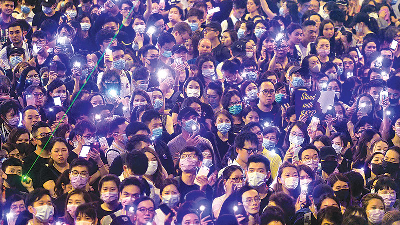 China rotates troops in HK as police ban new rally