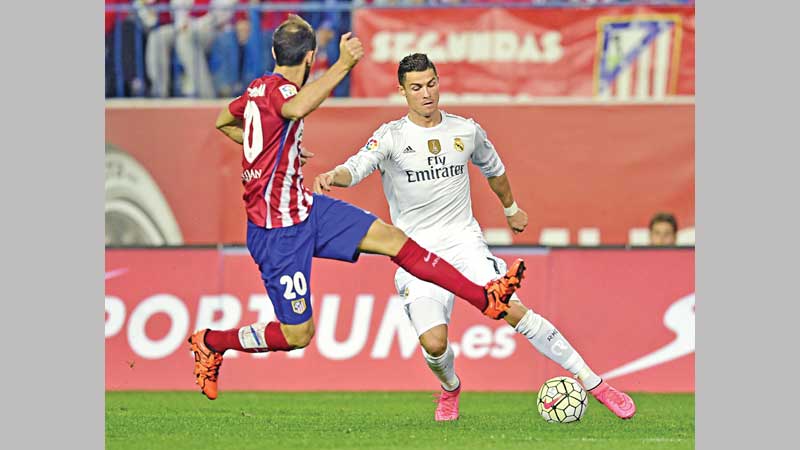 Real share derby spoils with Atletico