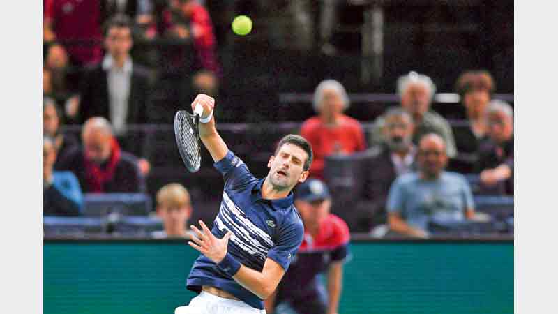 Djokovic survives scare, Nadal through