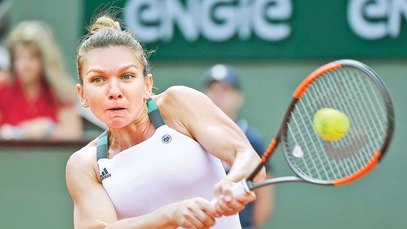 Halep hurries into French Open quarters