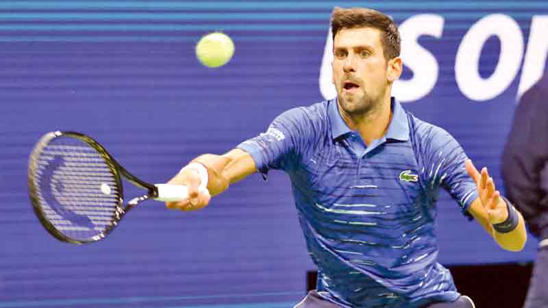 Hurting Djokovic, slow-starting Federer advance