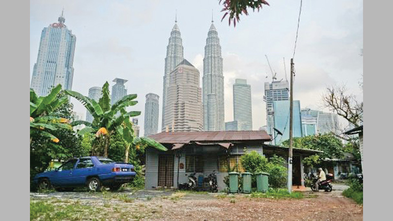 Malaysian capital seeks to free village trapped in time