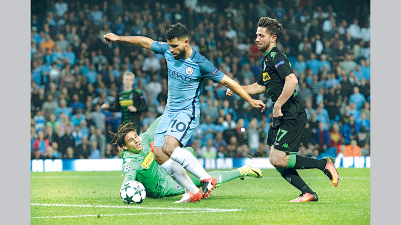 Manchester City ride on Aguero treble