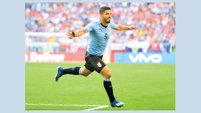 Suarez inspires Uruguay to 
top Group A in World Cup