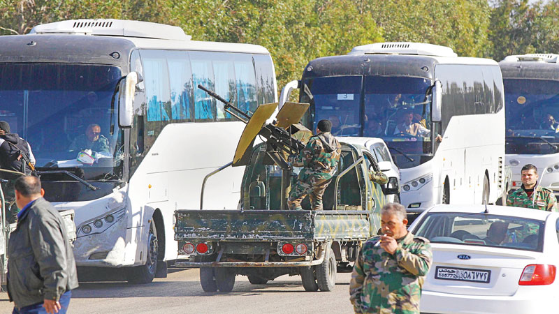 Syria rebels begin leaving Homs under truce deal