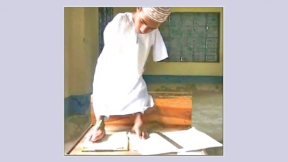Student without hands passes Dakhil exam by writing with leg