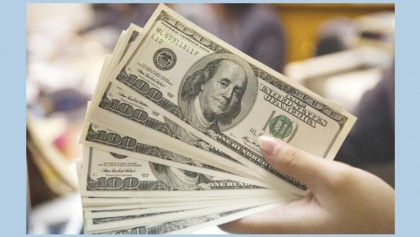 Dollar picks up ahead of Fed but stocks mostly retreat