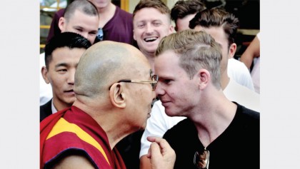 Smith rubs noses with Dalai Lama