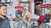 Beijing’s rickshaws teeter between tradition, survival