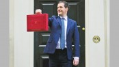 British budget extends austerity, cuts growth outlook